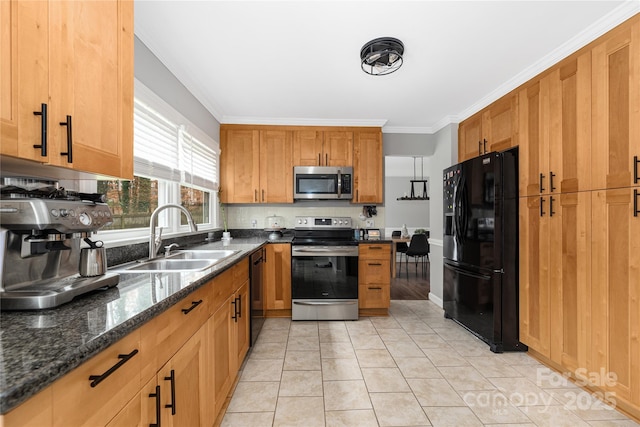 kitchen featuring sink, dark stone counters, light tile patterned floors, black appliances, and ornamental molding