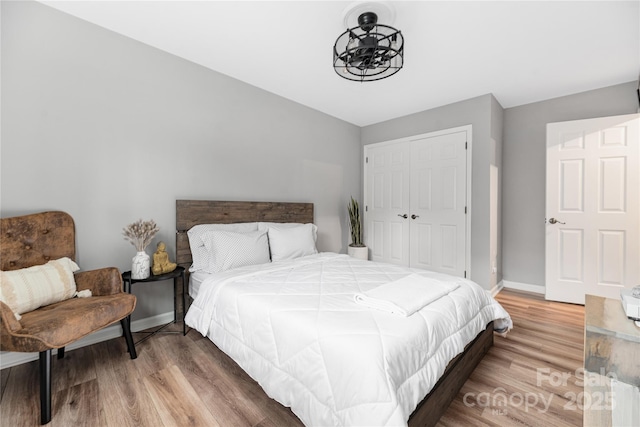 bedroom featuring hardwood / wood-style floors and a closet