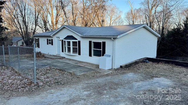 view of property exterior with a patio area and washer / dryer