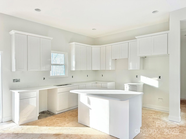 kitchen with white cabinets and a center island