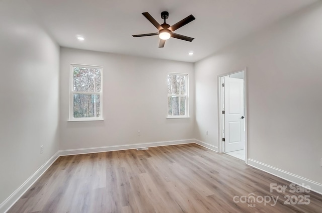 unfurnished room with a ceiling fan, recessed lighting, baseboards, and wood finished floors