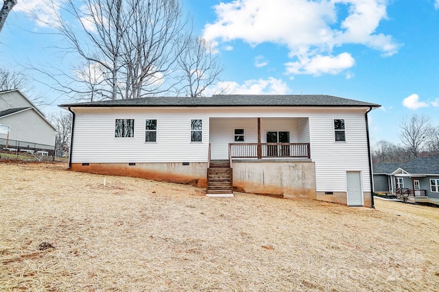 rear view of property featuring crawl space and covered porch