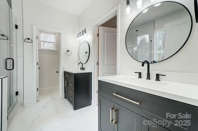 full bathroom featuring baseboards, marble finish floor, a sink, and a shower stall