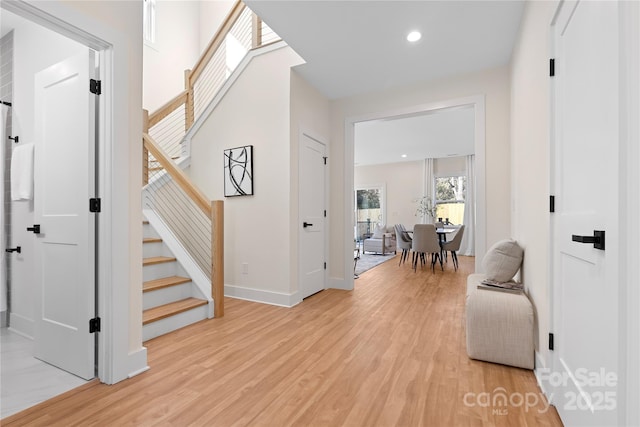 interior space featuring stairway, recessed lighting, baseboards, and light wood finished floors