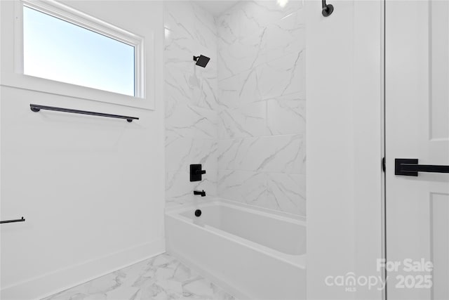 bathroom featuring baseboards, marble finish floor, and  shower combination