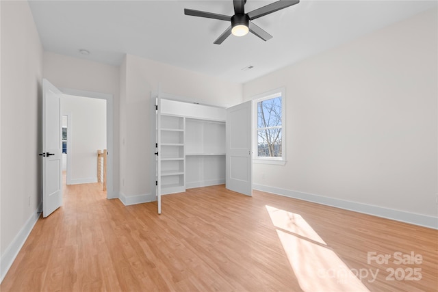 unfurnished bedroom with visible vents, baseboards, light wood-style flooring, ceiling fan, and a closet