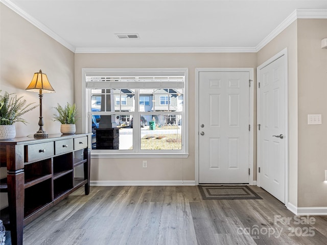 entrance foyer featuring hardwood / wood-style floors and crown molding