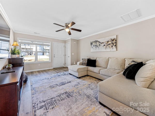 living room with ceiling fan, wood-type flooring, and crown molding