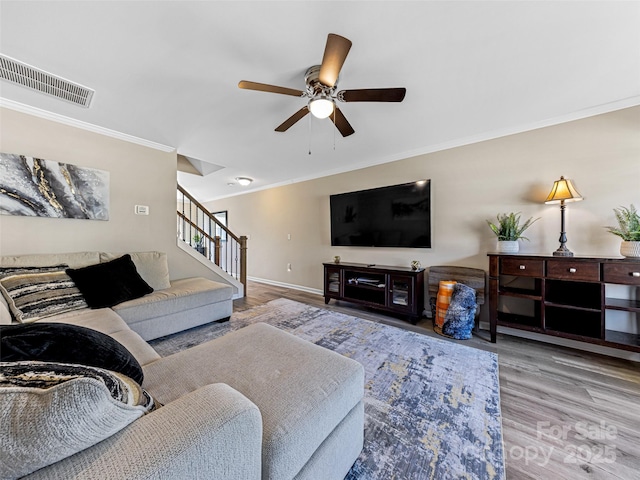 living room with ceiling fan, light hardwood / wood-style floors, and crown molding