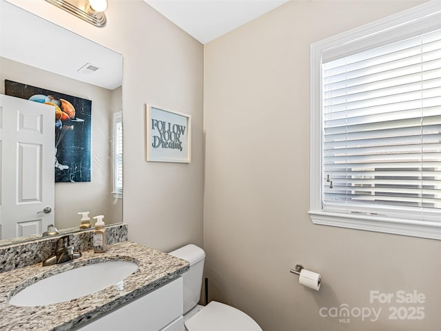 bathroom featuring vanity and toilet