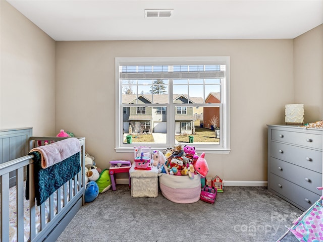 carpeted bedroom with a nursery area