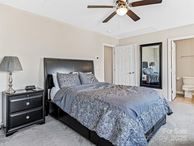 carpeted bedroom featuring ensuite bathroom and ceiling fan