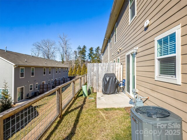 view of yard featuring a patio and central AC unit