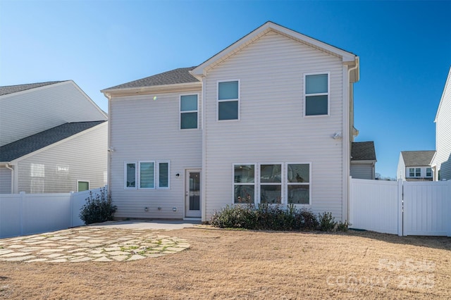 rear view of house with a patio area and a yard