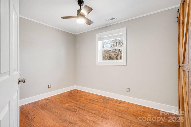 unfurnished room featuring ceiling fan, crown molding, and hardwood / wood-style floors