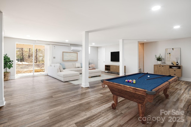 playroom featuring billiards, hardwood / wood-style flooring, and a wall mounted air conditioner