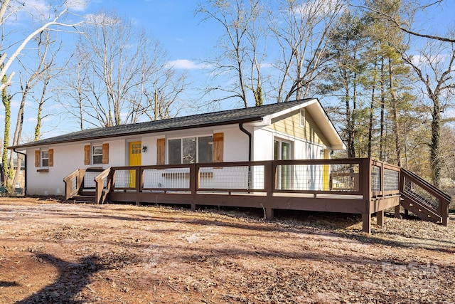 rear view of house featuring a deck