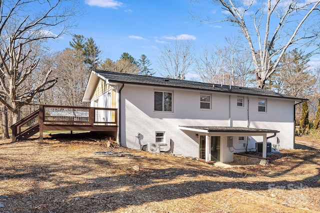 back of house with a wooden deck, ac unit, and central AC unit