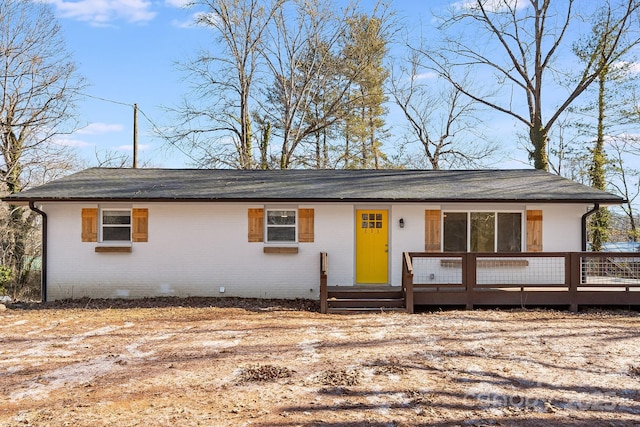 single story home featuring a wooden deck