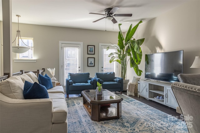 living room with ceiling fan and dark wood-type flooring