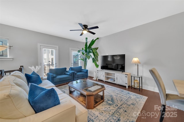 living room with dark hardwood / wood-style floors and ceiling fan