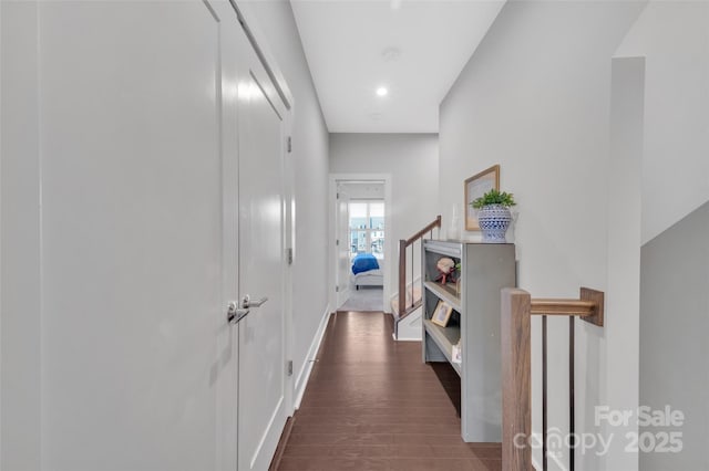 corridor with dark hardwood / wood-style flooring