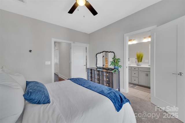 bedroom featuring connected bathroom, ceiling fan, and light tile patterned floors