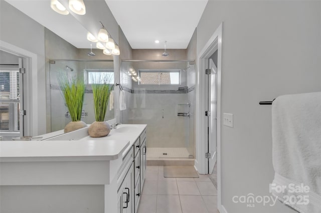 bathroom with vanity, tile patterned floors, and a shower with door