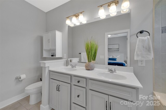 bathroom with vanity, tile patterned floors, and toilet