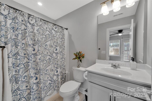 bathroom with vanity, toilet, and walk in shower