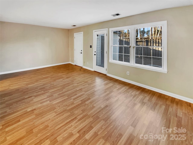 empty room with light hardwood / wood-style floors