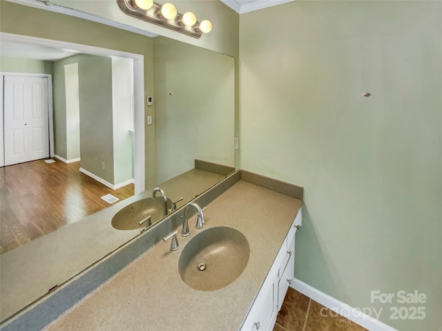 bathroom featuring tile patterned floors, vanity, and ornamental molding