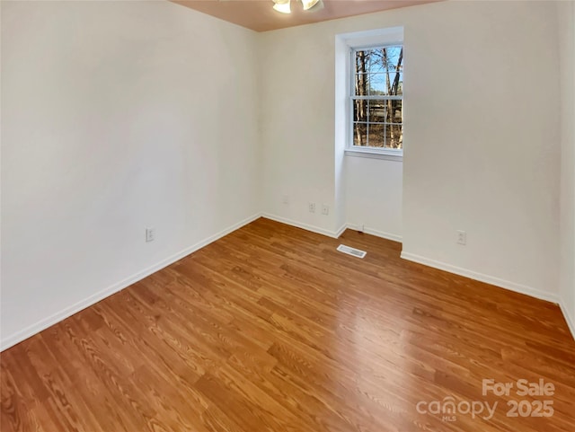 empty room with hardwood / wood-style floors