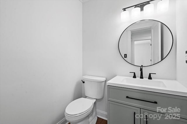 bathroom featuring vanity and toilet