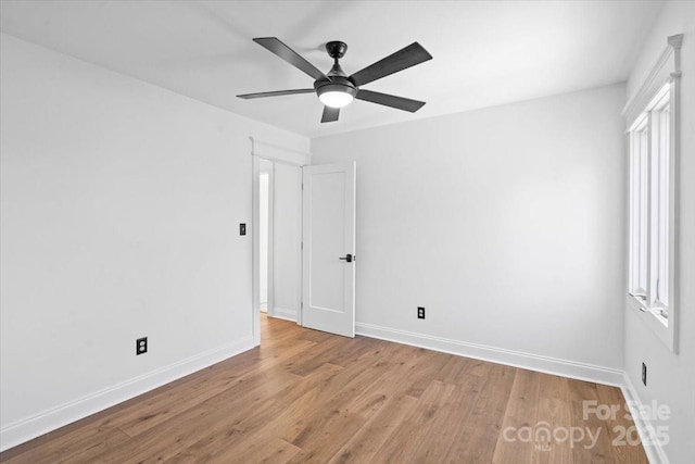 empty room featuring ceiling fan and light hardwood / wood-style flooring