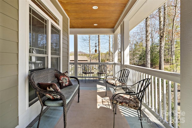 sunroom / solarium featuring wooden ceiling