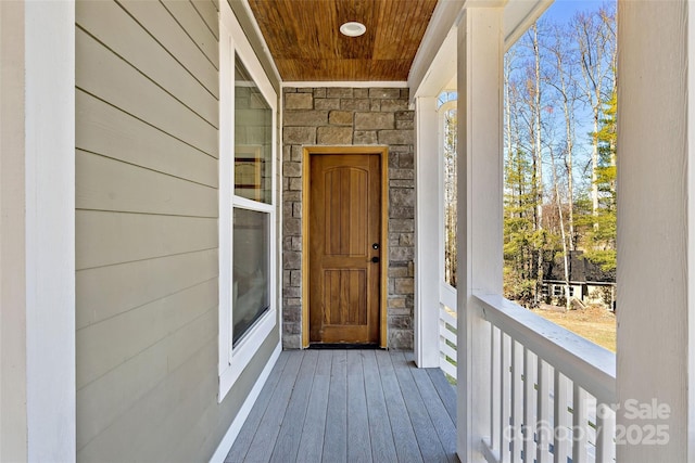 entrance to property featuring stone siding