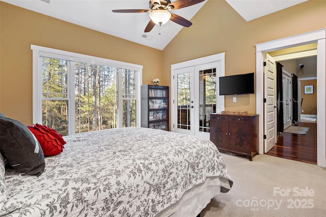 carpeted bedroom featuring french doors, visible vents, vaulted ceiling, ceiling fan, and access to outside