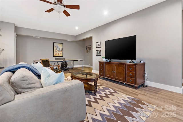 living room featuring light wood-style flooring, baseboards, ceiling fan, and recessed lighting