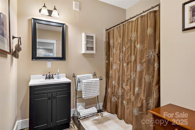 full bathroom with a shower with curtain, visible vents, vanity, and baseboards