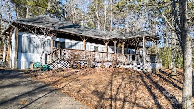 view of side of home with covered porch