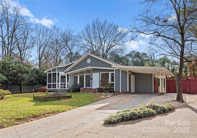 view of front facade featuring a carport, a sunroom, and a front lawn