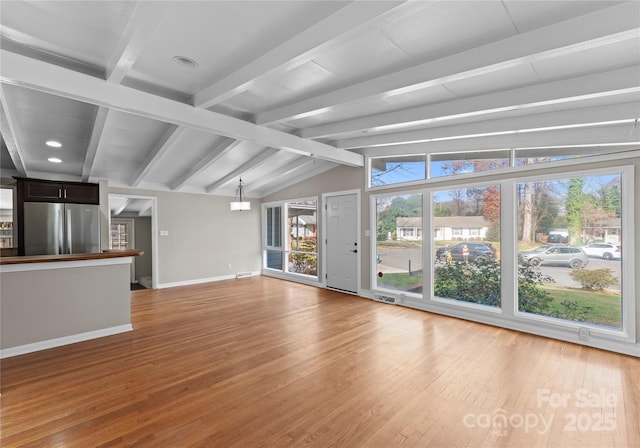 unfurnished living room with a healthy amount of sunlight and hardwood / wood-style flooring