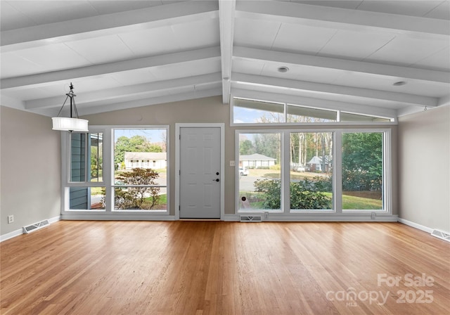 unfurnished living room with lofted ceiling with beams and hardwood / wood-style flooring