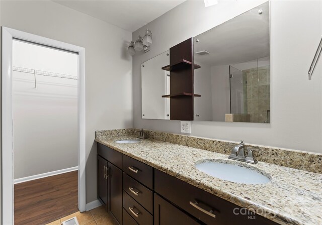 bathroom with vanity, tile patterned floors, and a shower with shower door