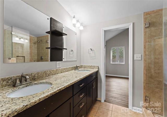 bathroom with lofted ceiling, tile patterned flooring, a shower with door, and vanity