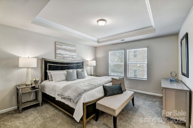 bedroom with carpet floors and a tray ceiling