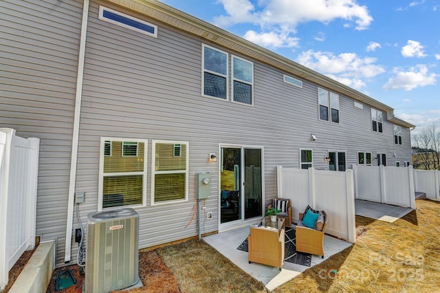 rear view of property featuring a patio area and central air condition unit