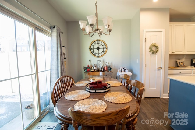 dining room featuring dark hardwood / wood-style flooring and an inviting chandelier