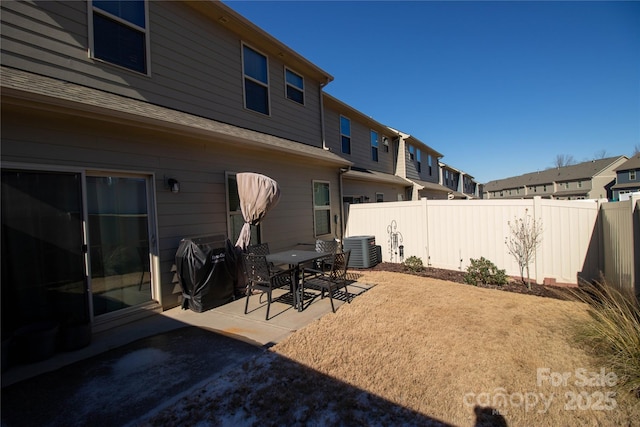 rear view of property featuring a patio area and cooling unit